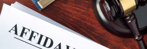 affidavit sitting on table with gavel