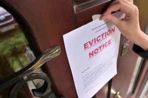 process server posting eviction notice on door