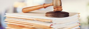Judge hammer and documents on background
