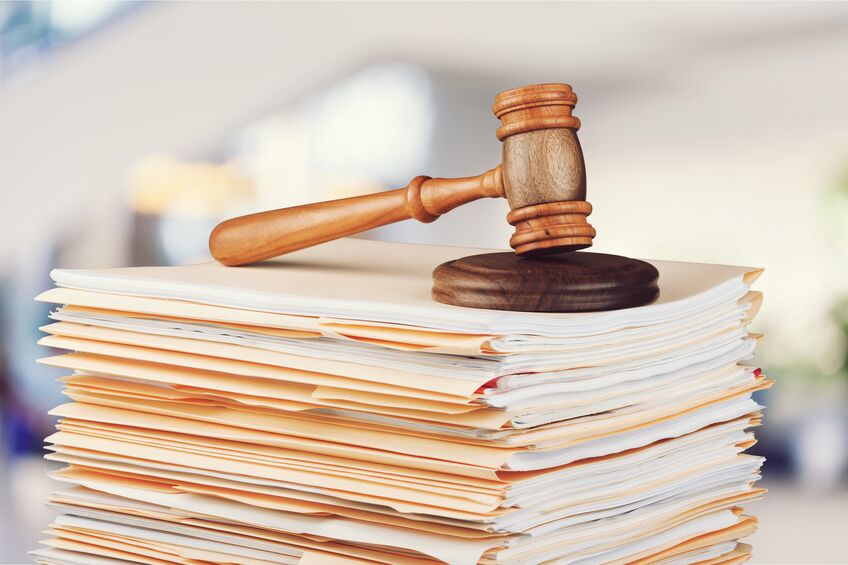 Judge hammer and documents on background