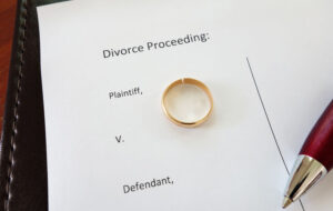 Divorce document with broken ring and pen
